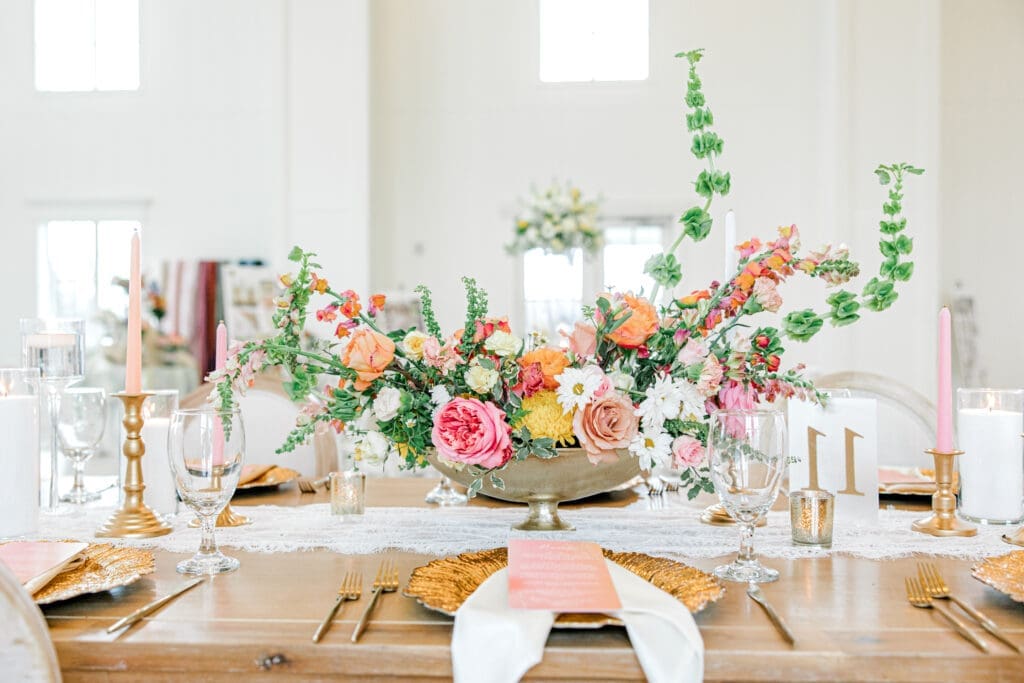 Elegant pink floral wedding tablescape with candlelight and beautifully styled reception décor at Etré Farms.