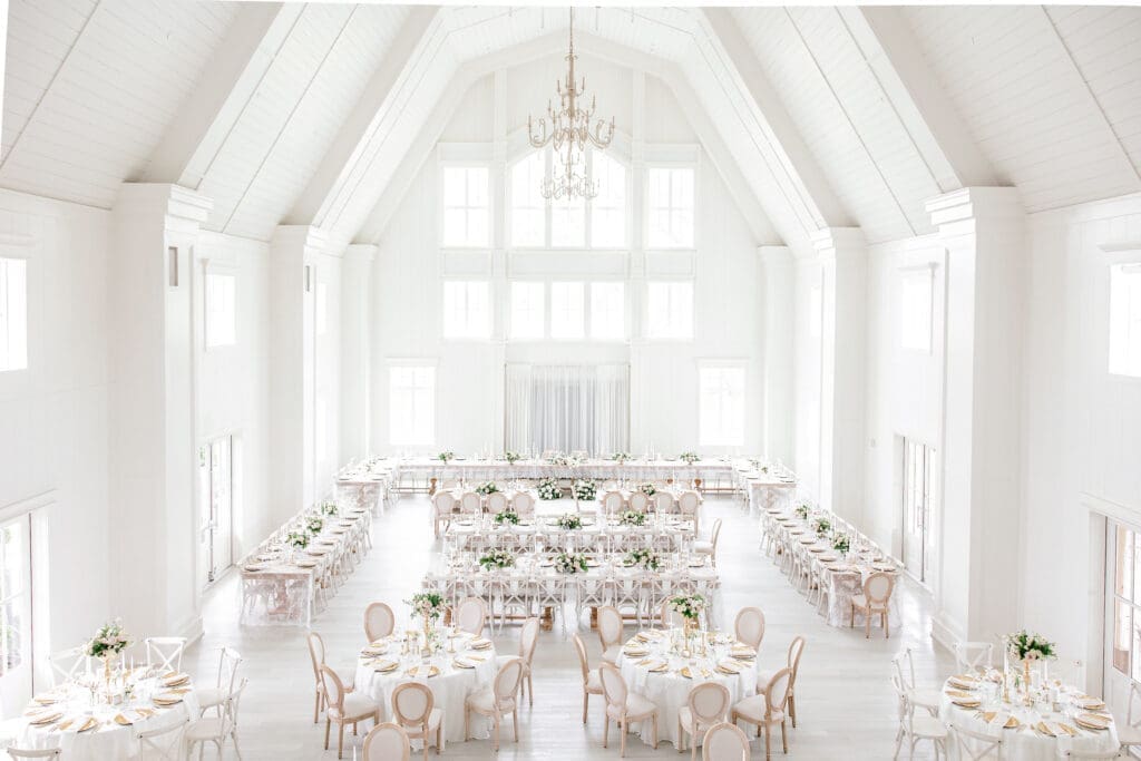 Elegant reception setup inside Etré Farms ballroom featuring romantic lighting, tables, and décor.